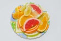 Plate of sliced orange, lemon, pink grapefruit and sweety